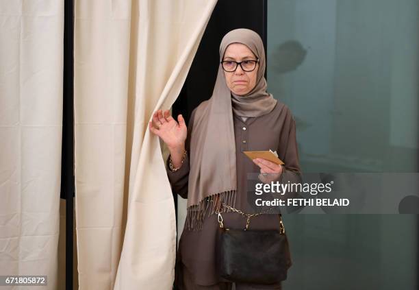 French national residing in Tunisia casts her vote for the first round of the French presidential election on April 23 at the French embassy in...