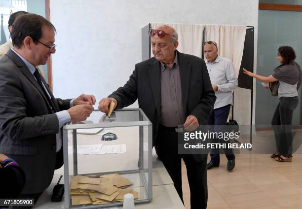 French national residing in Tunisia casts his vote for the first round of the French presidential election on April 23 at the French embassy in...