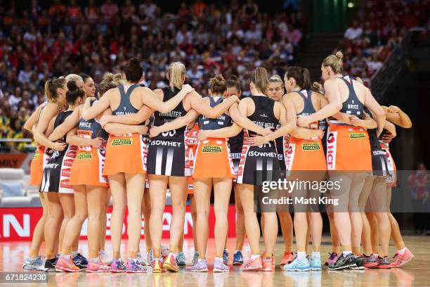 Players from both teams link arms before the round nine Super Netball match between the Giants and the Magpies at Qudos Bank Arena on April 23, 2017...