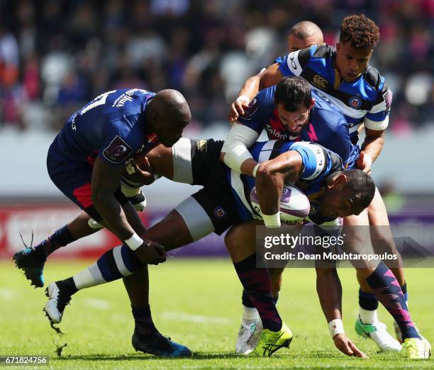 Semesa Rokoduguni of Bath Rugby is tackled and stopped by Djibril Camara, Will Genia and Geoffrey Doumayrou of Stade Francais during the European...
