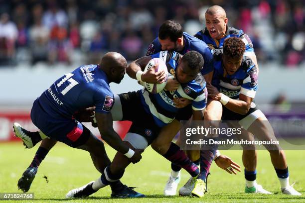 Semesa Rokoduguni of Bath Rugby is tackled and stopped by Djibril Camara, Will Genia and Geoffrey Doumayrou of Stade Francais during the European...