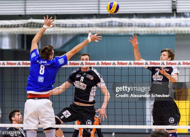 Georg Klein of Friedrichshafen in action against Graham Vigrass of Berlin and Robert Kromm of Berlin during the Volleyball final playoffs match 1...