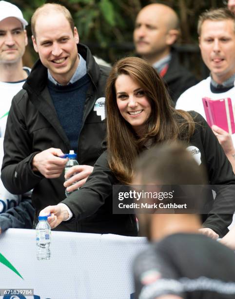 Prince William, Duke of Cambridge and Catherine, Duchess of Cambridge helping at a water station during the 2017 Virgin Money London Marathon on...