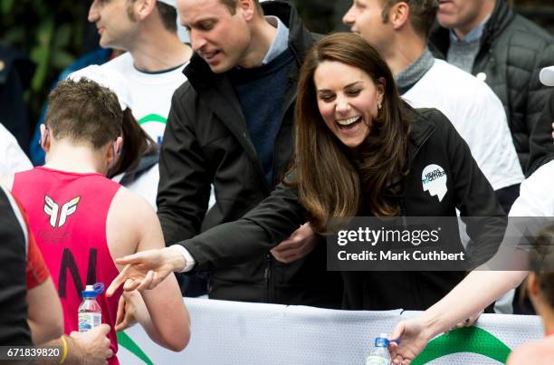 Prince William, Duke of Cambridge and Catherine, Duchess of Cambridge helping at a water station during the 2017 Virgin Money London Marathon on...