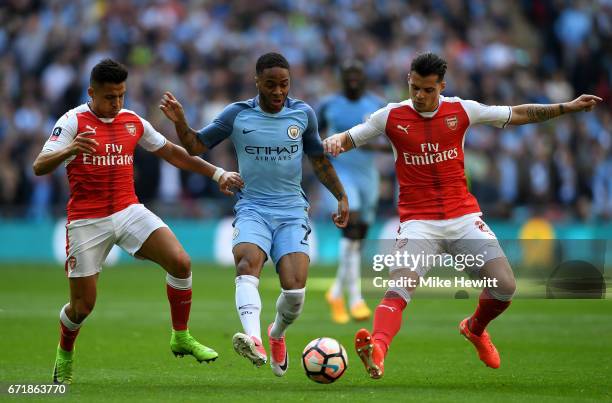 Raheem Sterling of Manchester City controls the ball under pressure of Alexis Sanchez and Granit Xhaka of Arsenal during the Emirates FA Cup...