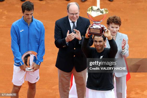 Spain's Rafael Nadal celebrates as he brandishes his trophy during the prize ceremony after winning the Monte-Carlo ATP Masters Series Tournament...