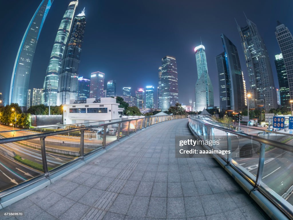 Illuminated footbridge against sky at night