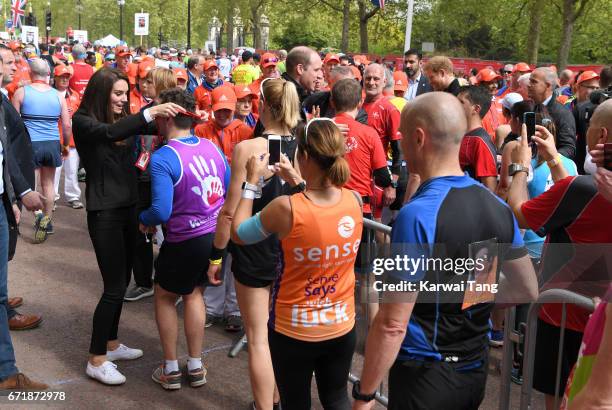 Catherine, Duchess of Cambridge, Prince William, Duke of Cambridge and Prince Harry give out medals to the finishers of the 2017 Virgin Money London...