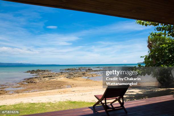 wooden beach chair on the terrace with sea view and blue sky. - beach cottage bildbanksfoton och bilder