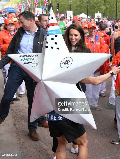 Catherine, Duchess of Cambridge gives out medals to the finishers of the 2017 Virgin Money London Marathon on April 23, 2017 in London, England.