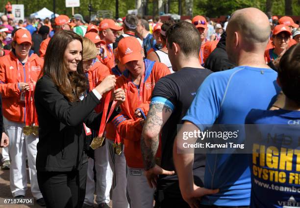 Catherine, Duchess of Cambridge gives out medals to the finishers of the 2017 Virgin Money London Marathon on April 23, 2017 in London, England.