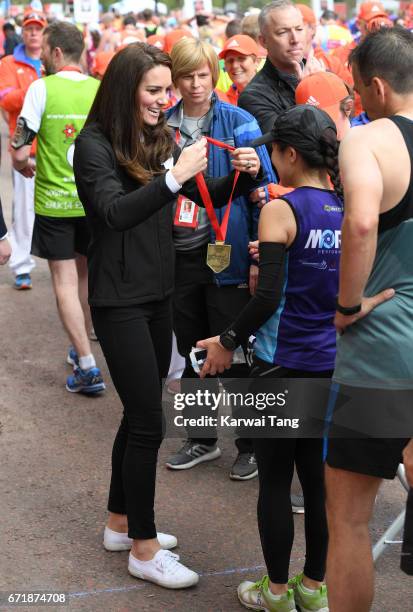 Catherine, Duchess of Cambridge gives out medals to the finishers of the 2017 Virgin Money London Marathon on April 23, 2017 in London, England.