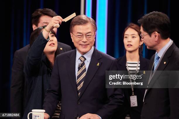 Moon Jae-in, presidential candidate of the Democratic Party of Korea, center, prepares for a televised presidential debate in Seoul, South Korea, on...