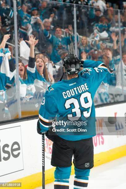 Logan Couture of the San Jose Sharks tosses a puck to a fan after the Sharks win a game against the Edmonton Oilers in Game Four of the Western...