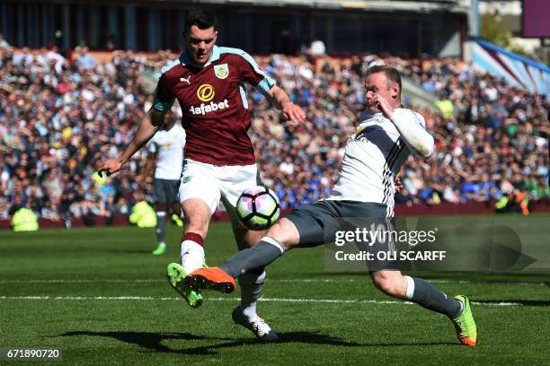 Manchester United's English striker Wayne Rooney vies for the ball with Burnley's English defender Michael Keane during the English Premier League...