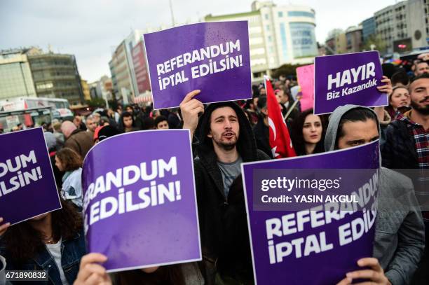 Demonstrators hold placards reading "Referendum should be cancelled" during a protest at the Kadikoy district in Istanbul on April 23, 2017 following...