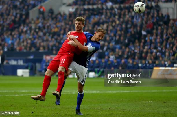 Timo Werner of Leipzig heads his teams first goal against Benedikt Hoewedes of Schalke during the Bundesliga match between FC Schalke 04 and RB...