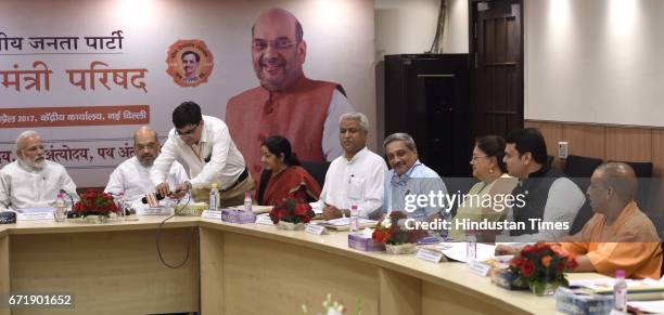 Prime Minister Narendra Modi and BJP President Amit Shah, during a meeting with 13 Chief Ministers of BJP-ruled states following the day-long meeting...
