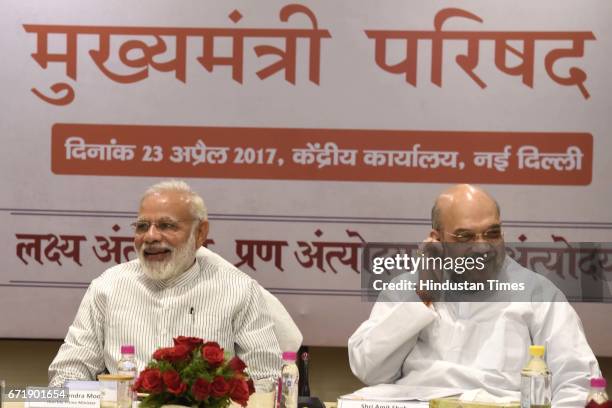 Prime Minister Narendra Modi and BJP President Amit Shah, during a meeting with 13 Chief Ministers of BJP-ruled states following the day-long meeting...