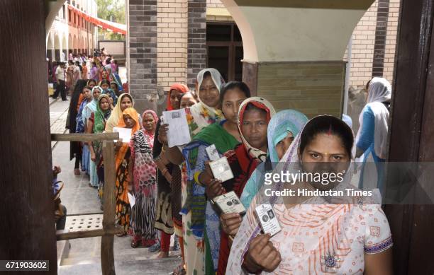 People stand in the queue to cast votes for the MCD Elections 2017 at Pandav Nagar, on April 23, 2017 in New Delhi, India. Voting for 270 seats...