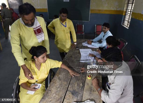 Swaraj India Party Chief Yogender Yadav with his party candidate arrives to cast his vote, during the MCD elections 2017, in East Delhi polling...