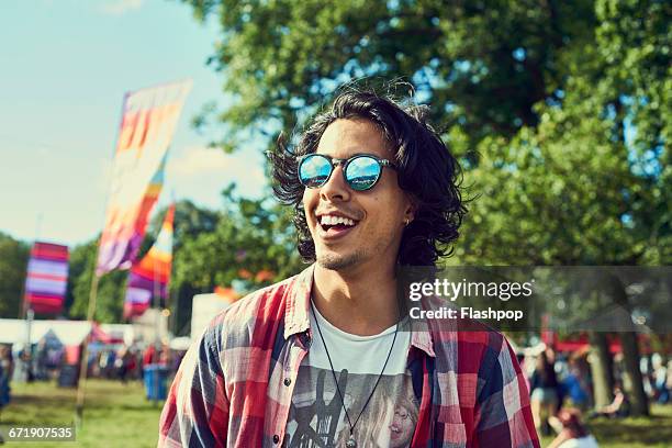 portrait of man having fun at a music festival - sunglasses ストックフォトと画像