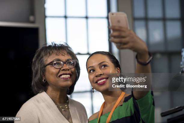 Anita Hill, professor of social policy, law and women's studies at Brandeis University, left, takes a selfie photograph with an attendee after a...