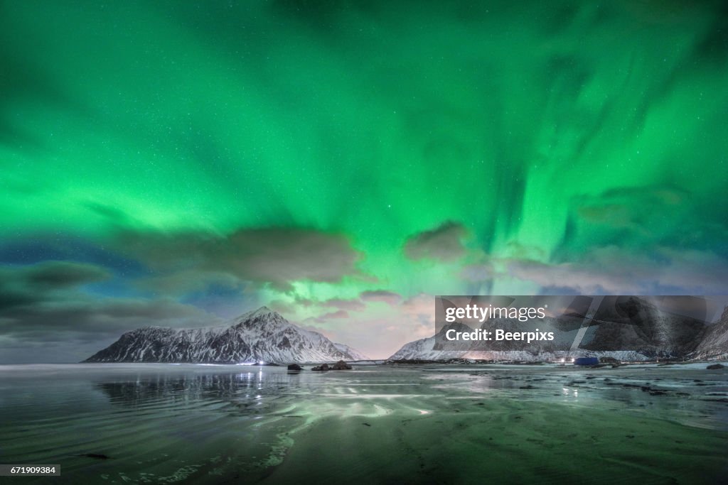 Aurora borealis over Skagsanden beach in Lofoten islands, Norway.