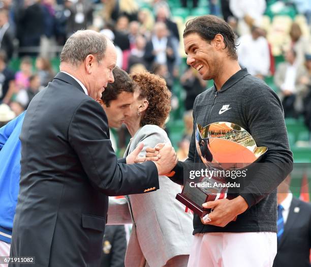 Spain's Rafael Nadal receives the trophy from Albert II , Prince of Monaco, after winning the Monte-Carlo ATP Masters Series Tournament against his...