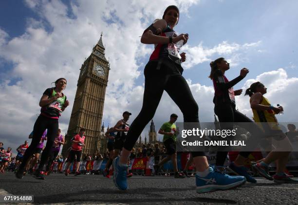 Runners pass Big Ben and the Houses of Parliament during the London Marathon in London on April 23, 2017.