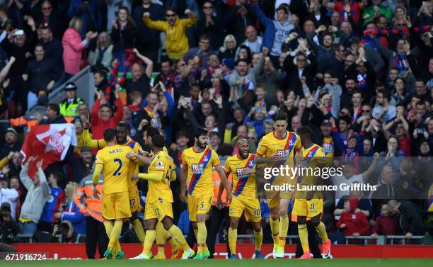 Christian Benteke of Crystal Palace celebrates his side's second goal with his team mates during the Premier League match between Liverpool and...