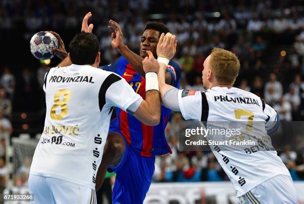 Wael Jallouz of Barcelona is challenged by Rene Toft Hansen and Blazenko Lackovic of Kiel during the EHF Champions League Quarter Final first leg...