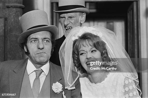 From left to right, English actors Harry H. Corbett , Wilfrid Brambell and Carolyn Seymour filming a movie spin-off of the British television sitcom...