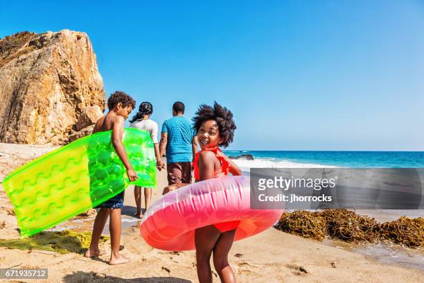 family of four at the beach - african ethnicity travel stock pictures, royalty-free photos & images
