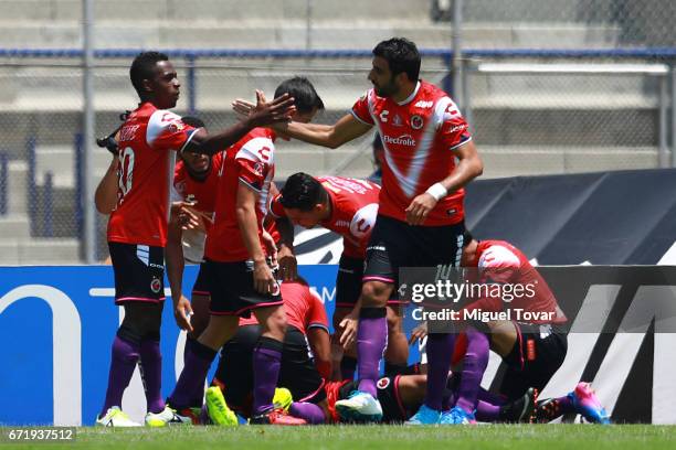 Cristian Pellerano and Jefferson Murillo of Veracruz celebrate the opening goal scored by Leandro Velazquez of Veracruz during the 15th round match...