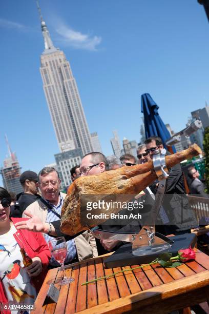 Fans enjoy carved meat during a roofop viewing party of El Clasico - Real Madrid CF vs FC Barcelona hosted by LaLiga at 230 Fifth Avenue on April 23,...