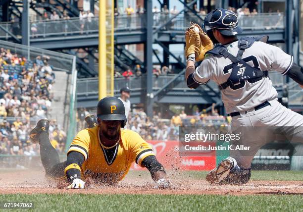 Andrew McCutchen of the Pittsburgh Pirates scores on an RBI double in the third inning against Kyle Higashioka of the New York Yankees at PNC Park on...