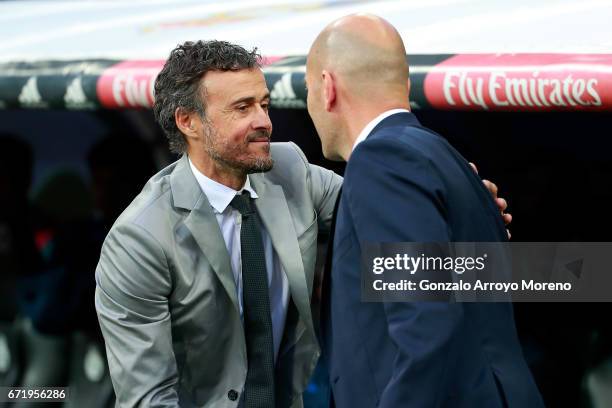 Luis Enrique the manager of Barcelona greets Zinedine Zidane head coach of Real Madrid prior to kickoff during the La Liga match between Real Madrid...