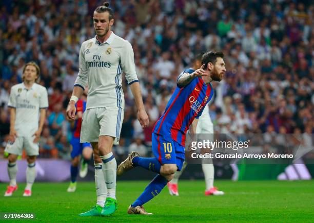 Lionel Messi of Barcelona celebrates as he scores their first and equalising goal as Gareth Bale of Real Madrid looks dejected during the La Liga...