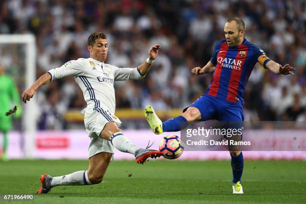 Cristiano Ronaldo of Real Madrid and Andres Iniesta of Barcelona battle for the ball during the La Liga match between Real Madrid CF and FC Barcelona...