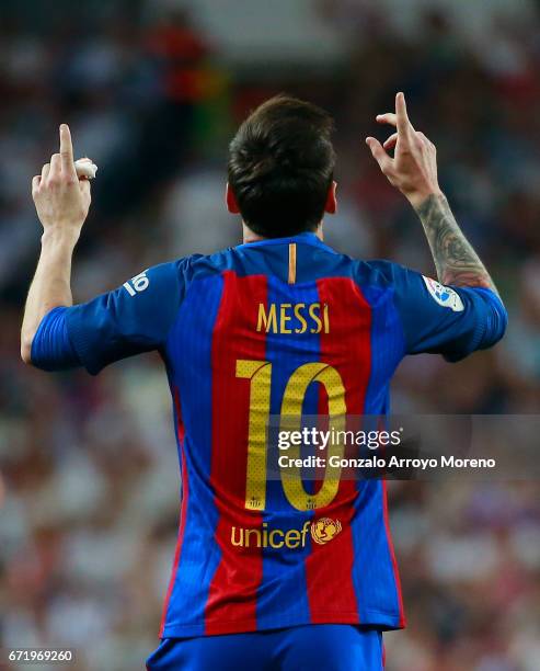 Lionel Messi of Barcelona celebrates as he scores their first and equalising goal with team mates during the La Liga match between Real Madrid CF and...