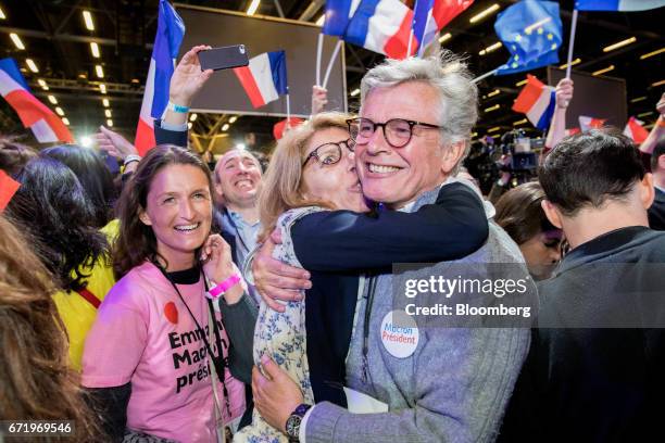 Attendees react as results for the first round of the French presidential election are projected at an En Marche party in the Parc des Expositions in...