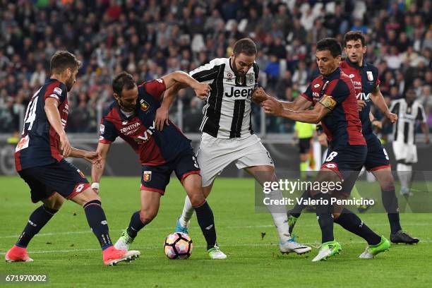 Gonzalo Higuain of Juventus FC is challenged by Santiago Gentiletti and Nicolas Burdisso of Genoa CFC during the Serie A match between Juventus FC...