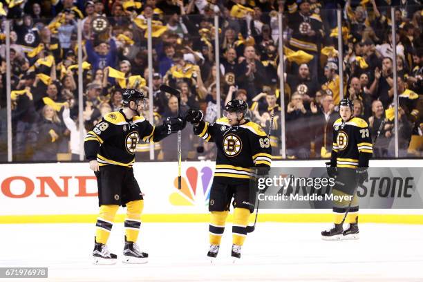 Drew Stafford of the Boston Bruins celebrates with Brad Marchand after scoring against the Ottawa Senators during the first period of Game Six of the...