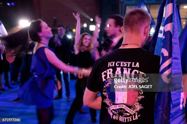 Supporters of French presidential election candidate for the far-right Front National party dance after the announcement of the first round of the...