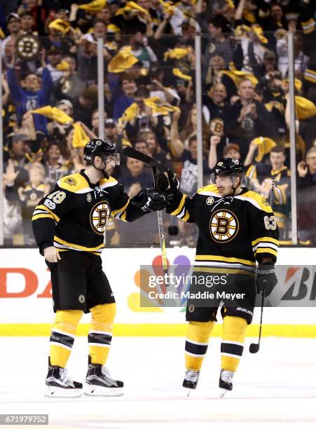 Drew Stafford of the Boston Bruins celebrates with Brad Marchand after scoring against the Ottawa Senators during the first period of Game Six of the...