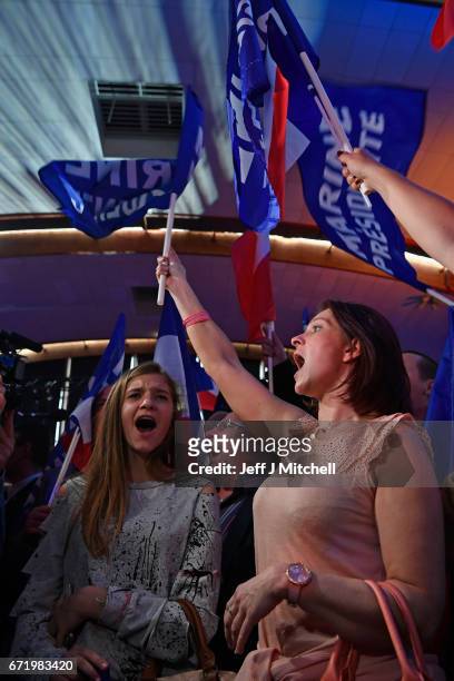 Supporters of National Front leader Marine Le Pen cheer in celebration in the Espace Francios Mitterrand on April 23, 2017 in Henin Beaumont, France....