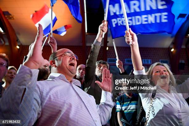 Supporters of National Front leader Marine Le Pen cheer in celebration in the Espace Francios Mitterrand on April 23, 2017 in Henin Beaumont, France....