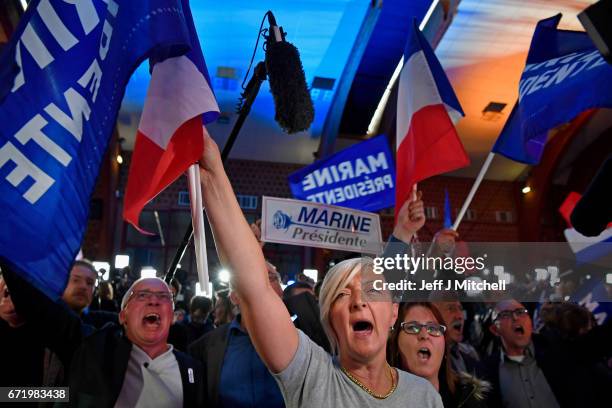 Supporters of National Front leader Marine Le Pen cheer in celebration in the Espace Francios Mitterrand on April 23, 2017 in Henin Beaumont, France....