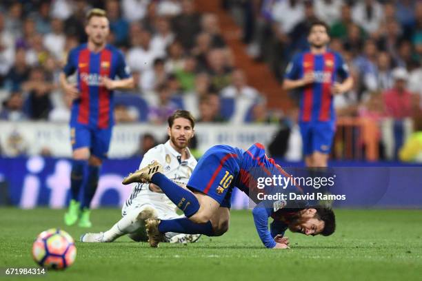 Sergio Ramos of Real Madrid fouls Lionel Messi of Barcelona and is sent off during the La Liga match between Real Madrid CF and FC Barcelona at...